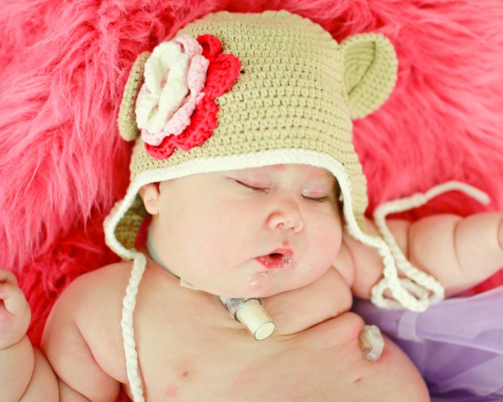 Stella wearing a crocheted bear hat